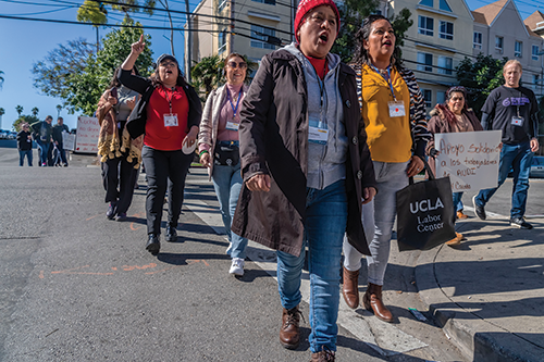 Norma Palacios (in red hat) with  domestic workers rallying in Los Angeles on behalf of striking workers at an Audi plant in Mexico, February 10, 2024.  Credit: © David Bacon. 