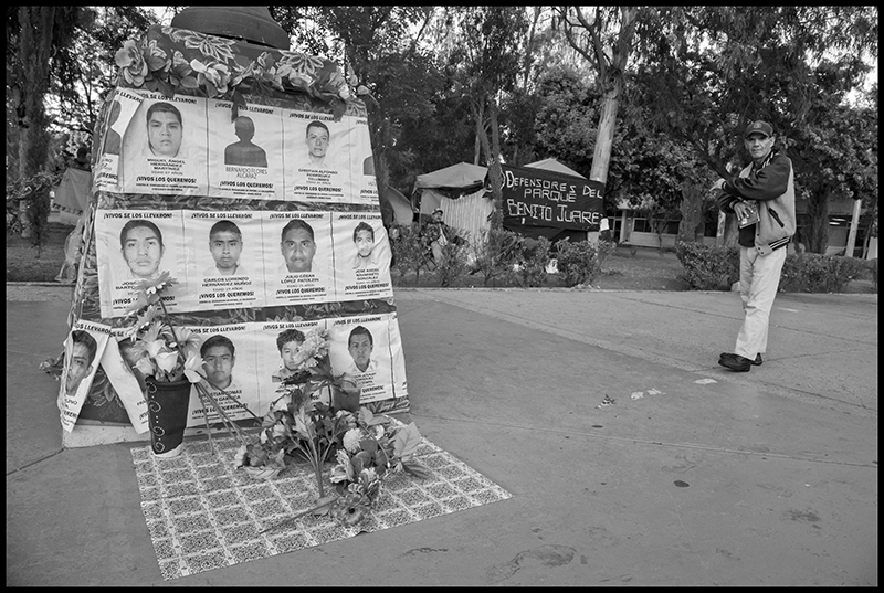 Daniel Taramayateca stands near the memorial the camp residents have made to honor the 43 students kidnapped and possibly murdered at the Ayotzinapa teachers' training school in Guerrero.