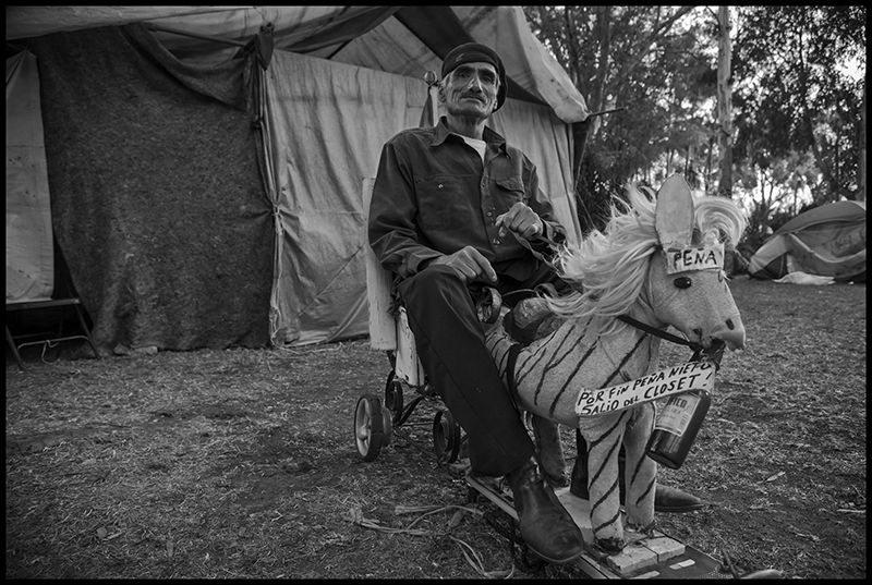 Felipe Gomez, a former baker, has been a leader of the encampment from the beginning. His horse says, 